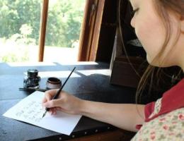 Female interpreter writing with pen and ink